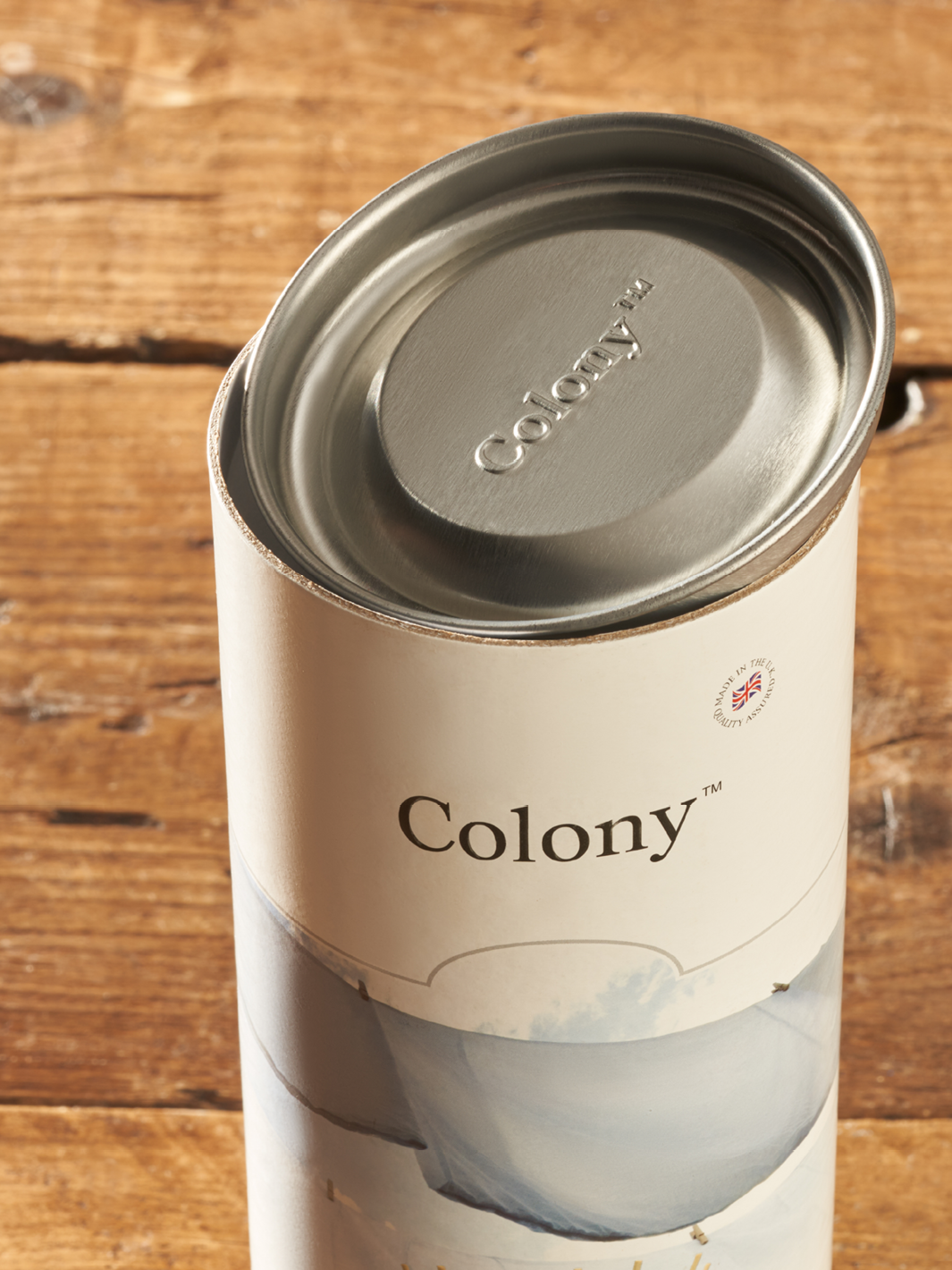 One piece cardboard tube with a metal plug lid.