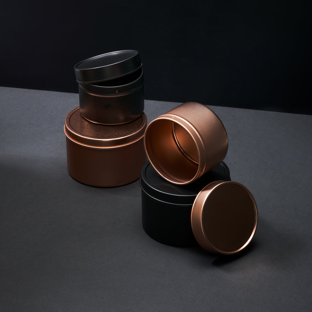 T0766 tin collection in Black, rose gold, and two different sizes.